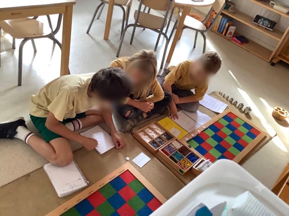 Primary children working together on the floor with the checkerboard and stamp game