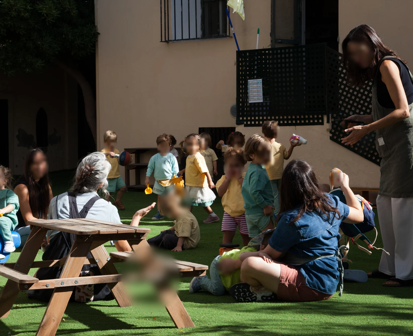 A child working independently at an outdoor table with a timer, notebook and pencils