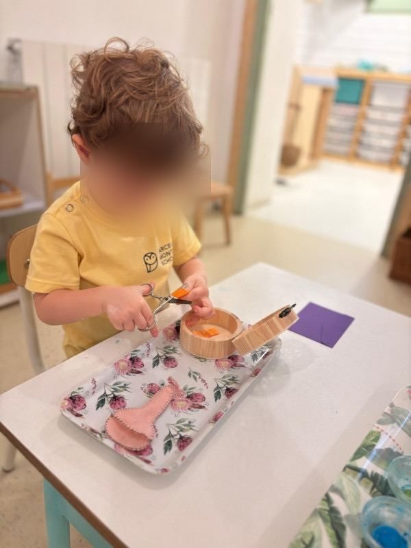 A child working on a spooning activity