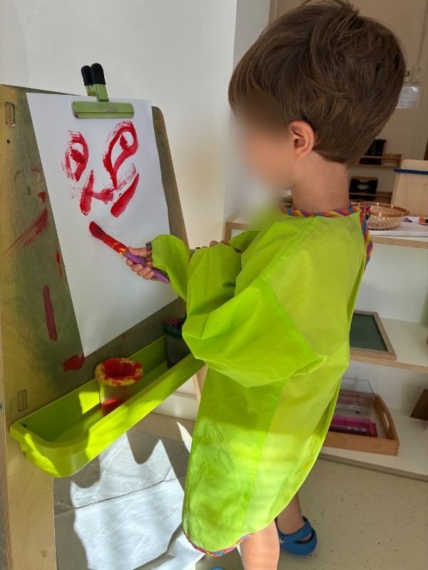 A child painting at the easel