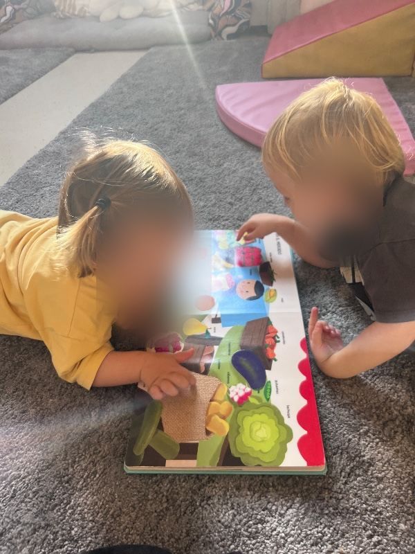 Two Nido children exploring a puzzle together